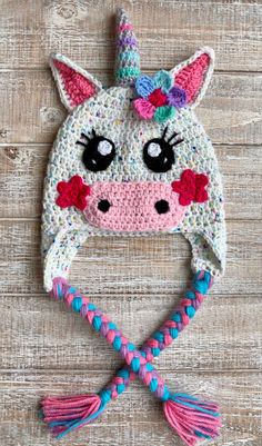 a crocheted hat with a unicorn face on it