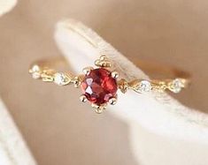 Dainty Ruby Ring For Anniversary, Red Minimalist Jewelry For Wedding, Minimalist Red Jewelry For Wedding, Dainty Ruby Ring With Birthstone, Dainty Ruby Ring With Prong Setting, Elegant Red Stackable Rings, Delicate Red Round Jewelry, Minimalist Ruby Birthstone Promise Ring, Dainty Red Solitaire Ruby Ring