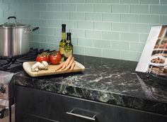 the kitchen counter is clean and ready to be used as a cookbook, wine bottle, and other cooking utensils