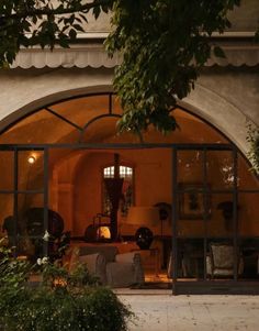 an arched glass door leading into a living room