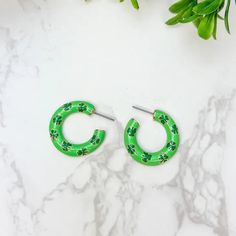 Add a touch of luck to your outfit with our Green Clover Hoop Earrings. 1"Hoop Green Small Hoop Earrings For Spring, Green Hoop Earrings For Spring, Green Hoop Earrings As Spring Gift, Green Hoop Earrings Spring Gift, Trendy Small Hoop Green Earrings, Green Spring Hoop Earrings For Gift, Green Spring Hoop Earrings Gift, Trendy Green Hoop Earrings For Spring, Trendy Green Small Hoop Earrings