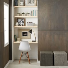 a white chair sitting in the middle of a room next to a bookshelf