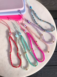 Beaded phone lanyard with evil eye bead 🧿 to be attached to your phone case   These can be looped through your phone case or looped through one of our heart shaped phone charm holders below:   https://www.etsy.com/uk/listing/1410899591/phone-holderphone-gripphone-charm-holder?click_key=5cd45d79fa174ea244000f274678d1d0e01f7ff9%3A1410899591&click_sum=7b0ed69c&ref=shop_home_active_6&pro=1 Gift packaged in our organza gift bag with business card Charms For Phone Cases, Cute Phone Strap, Charm Phone Cases, Phone Holder Beads, Beaded Phone Case, Phone Case Charms, Evil Eye Phone Charm, Cute Phone Charms, Beaded Phone Charms