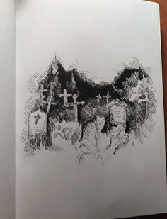 an open book with a drawing of two people on the cross in front of them