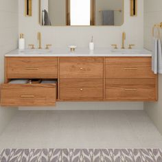 a bathroom with two sinks and mirrors on the wall