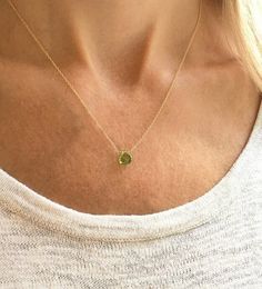 "This genuine peridot gemstone sits on a dainty and minimalist 14k gold filled, sterling silver, rose gold filled, or 14k gold chain. Subtle and simple, this beautiful semi-precious stone necklace is perfect by itself or for layering with other necklaces. Peridot is the August birthstone necklace and would make the perfect birthday gift. Available in many gemstones and birthstones in the drop down menu. Model is wearing the peridot necklace in 16\" gold filled. Jewelry is handmade by us in our NYC studio. We focus on craftsmanship and quality using only the highest quality materials and handpicked genuine gemstones.  PACKAGING We take pride in creating beautifully packaged orders. Jewelry arrives delicately wrapped in tissue and placed in a kraft box inside a logo drawstring pouch. Your pa Minimalist Yellow Gold Birthstone Necklace With Delicate Chain, Minimalist 14k Gold Birthstone Necklace, Dainty 14k Gold Charm Necklace For May Birthstone, Green Gemstone Charm Necklace In Sterling Silver, Green Gemstone Sterling Silver Charm Necklace, Dainty 14k Gold May Birthstone Charm Necklace, Minimalist 14k Gold-filled Birthstone Necklace With Delicate Chain, Minimalist 14k Gold Filled Birthstone Necklace With Delicate Chain, Minimalist 14k Gold Charm Necklaces With Gemstone