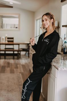 a woman standing on top of a kitchen counter