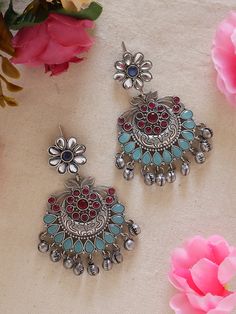 Discover elegance in our Pink Blue Ethnic Silver Earrings with Ghungroos. Meticulously handcrafted, these earrings seamlessly fuse traditional charm with contemporary style. The vibrant pink and blue and silver combination, coupled with intricate ghungroos, adds a unique flair to any outfit. Lightweight and versatile, they're perfect for both casual and formal occasions, allowing you to effortlessly embrace cultural sophistication. Elevate your style with these statement earrings that blend tradition and modernity with finesse. Available in two more stunning colour options.  In case of any queries, please feel free to contact us. Happy shopping! Festive Fusion Earrings With Oxidized Finish, Fusion Style Oxidized Chandbalis Gift, Fusion Style Oxidized Chandbalis For Gifts, Fusion Style Oxidized Chandbalis As Gift, Fusion Style Oxidized Chandbalis, Fusion Oxidized Finish Chandbalis As Gift, Traditional Oxidized Drop Earrings Jhumkas, Traditional Oxidized Jhumkas Drop Earrings, Traditional Oxidized Finish Jhumkas Drop Earrings