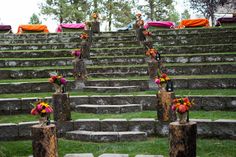 many vases with flowers are sitting on stone steps