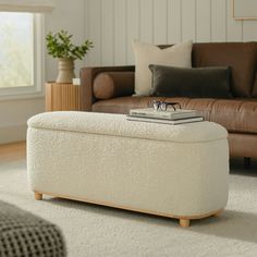 a living room with a couch, chair and footstool on the carpeted floor