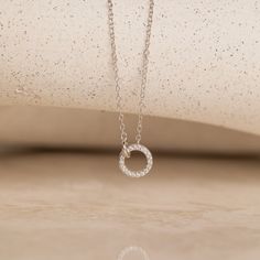 This Interlocking Dainty Charm Necklace is delicately crafted to capture the essence of elegance, making it the perfect piece of minimal diamond Jewelry for brides and a cherished wedding gift. It can be worn on your special day as a symbol of love and commitment, and cherished as a timeless keepsake to commemorate the start of your forever. Material: High Quality Solid 925 Sterling Silver Finish: Sterling Silver ∙ 18K Gold Featuring a ~8mm & 4.5mm Pave CZ Diamond Linked Pendant on an adjustable White Gold Necklace With Si Clarity As A Gift, Elegant Silver Open Circle Necklace, Elegant Open Circle Silver Necklace, Dainty Diamond White Jewelry With Si Clarity, Modern Diamond Necklace With Delicate Chain, Timeless Sterling Silver Diamond Necklace For Wedding, Minimalist Round Cut Jewelry With Si Clarity, Minimalist Round Cut Si Clarity Jewelry, Minimalist Si Clarity Round Cut Jewelry