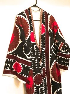 "Vintage fully embroidered Uzbek kimono coat Size M/L This is a gorgeous antique handmade embroidered suzani robe dress. This magnificent piece of art is part of the interesting culture and traditions of the people of Tajikistan and Uzbekistan. Suzani embroideries are used as an element of interior decoration and also as a ritual symbol connected with the ancient beliefs of this culture. The Suzani designs are flowers, nest, images of birds, and other ancient symbols. Measurements: Shoulder to s Traditional Shawl Kaftan For Festivals, Traditional Brown Kimono For Fall, Traditional Kimono With Patterns For Festival, Traditional Brown Kimono For Festival, Traditional Festival Kimono With Patterns, Traditional Multicolor Shawl Outerwear, Traditional Shawl Kimono For Fall, Traditional One-size Kimono With Kimono Sleeves, Traditional One-size Shawl Kimono