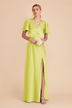 a woman wearing a lime green dress with short sleeves and a slit down the side