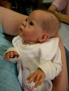 a woman holding a baby in her arms