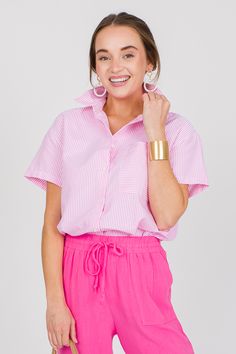 Pink stripe button up with spring-appropriate short sleeves and a single chest pocket. Notched sides give way to a longer length in the back. Spring Shirt With Vertical Stripes And Shirttail Hem, Striped Short Sleeve Shirt With Pockets, Pink Short Sleeve Top With Striped Collar, Casual Striped Short Sleeve Blouse, Vertical Striped Shirt For Day Out In Spring, Striped Short Sleeve Cotton Blouse, Spring Short Sleeve Horizontal Stripe Tops, Striped Cotton Short Sleeve Blouse, Summer Short Sleeve Blouse With Striped Collar