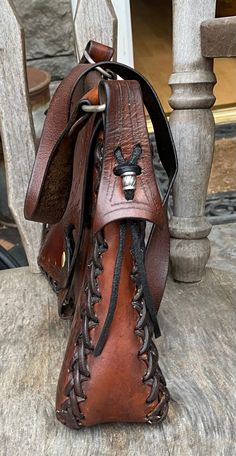 Western Style Brown Hand Tooled Shoulder Bag, Western Style Hand Tooled Brown Shoulder Bag, Handmade Brown Bohemian Saddle Bag, Western Brown Satchel Shoulder Bag, Brown Leather Saddle Bag For Festival, Western Style Brown Shoulder Bag With Adjustable Strap, Brown Crossbody Saddle Bag For Festival, Western Brown Shoulder Bag With Adjustable Strap, Handmade Brown Saddle Bag