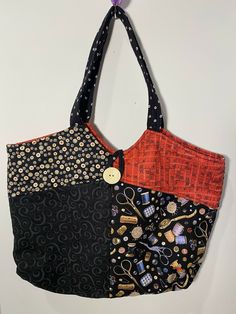 a handbag hanging on the wall with buttons and other things in it's pocket