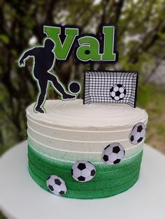 there is a cake that has soccer decorations on it