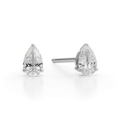 Perfect your everyday look with the timeless sparkle of these dainty pear-shaped diamond solitaire stud earrings in white gold. Crafted in 14K white gold Each earring showcases a 1/10 ct. pear-shaped diamond solitaire. Great for layering and stacking with other earring styles Shimmering with 1/5 ct. t.w. of diamonds These post earrings secure comfortably with friction backs. Classic Pear-shaped White Gold Diamond Earrings, Classic White Teardrop Earrings With Diamond Accents, Fine Jewelry White Gold Pear Diamond Earrings, White Gold Pear-shaped Diamond Cut Earrings, Classic Pear Shaped Diamond Earrings, Fine Jewelry Pear Shaped White Gold Diamond Earrings, Pear-shaped White Gold Diamond Earrings, Classic Drop Diamond Earrings With Prong Setting, Timeless White Pear-shaped Diamond Earrings