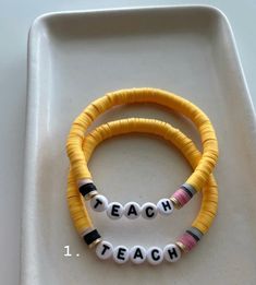 two bracelets that say teach on them