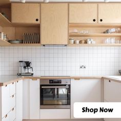 a kitchen with wooden cabinets and white tile backsplash, along with the words shop now