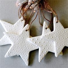 three white ceramic stars hanging from a string