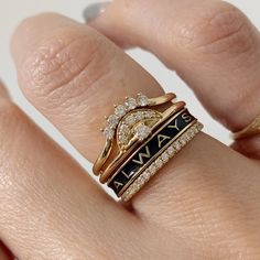 a close up of a person's hand with two rings on their fingers and one ring in the middle