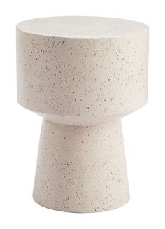 a white table with speckles on the top and bottom, against a white background