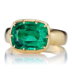 3.93ct Emerald Ring in East-West Setting The Allie 3.93 ring is an AB original design made right here in NYC. The ring centers a C Dunaigre-certified 3.93-carat cushion cut Zambian Emerald of Minor clarity enhancement. The stone is collet set in our signature 18kt yellow gold setting. The ring is currently size 6.25 and can be resized! Why We Love It A bright and vibrant Emerald centers this chunky, golden number. A Victorian-inspired beauty that makes a statement or stacked with bands for a loo Luxury Emerald Ring With Cushion Cut Center Stone, Luxury Cushion Cut Emerald Ring With Center Stone, Luxury Cushion Cut Emerald Ring, Luxury Prong-set Cushion Cut Emerald Ring, Luxury Cushion Cut Emerald Ring With Prong Setting, Luxury Yellow Gold Cushion Cut Emerald Ring, Luxury Cushion Cut Emerald Ring In Yellow Gold, Gia Certified Luxury Square Cut Emerald Ring, Luxury Gia Certified Square Cut Emerald Ring