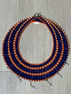 This bold and colorful african necklace is worn among the Maasai people of Kenya during weddings and special festivals. This hand-made maasai necklace can be worn individually or stacked or styled with contemporary pieces to create a unique look. Triple bound Maasai Collar. Maasai People, African Necklace, Ear Climbers, Maasai, Guinea Bissau, Caribbean Netherlands, Vintage Metal, Kenya, Stones And Crystals