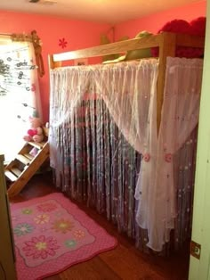 there is a bunk bed with curtains and pink rugs in the room next to it