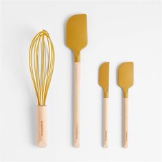 three yellow kitchen utensils with wooden handles