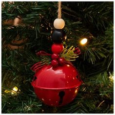 a red christmas ornament hanging from a tree