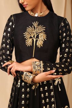 Editor's Note This Black Crepe Lehenga Set Has High Neck Blouse With Contrasting Front Which Is Adorned With Aari Embroidery And Printed Wallflower Back And Sleeve Embellished With Embroidered Borders, It Also Has A Centre Back Opening To Dazzle At A Special Occasion! The Lehenga Has Beautiful Alternating Panels In Wallflower & Coco And Is Edged With Kinari, It Also Has Pocket. Organza Dupatta Is Embellished With Embroidered Borders And Tassel Detail To Give A Desi Vibe! Fabric: Crepe, Raw Silk Crepe Lehenga, House Of Masaba, Caribbean Fashion, Blouse Yoke, Lehenga Dupatta, Organza Lehenga, High Neck Blouse, Aari Embroidery, Lakme Fashion Week