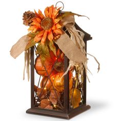 a lantern filled with lots of fall decorations