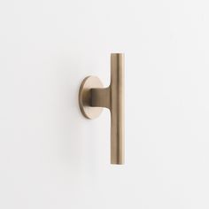 a close up of a door handle on a white wall