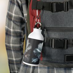 a person wearing a backpack with a water bottle in the back pocket and a lanyard around his waist