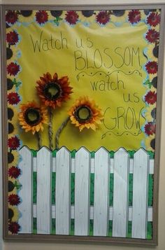 a painting with sunflowers on the fence and words written below it that says watch us blossom, watch us grow