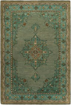 a green rug with an ornate design on the center and sides, in various colors