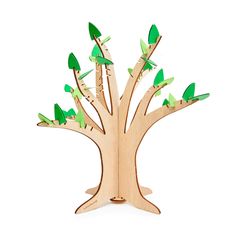 a wooden tree with green leaves on it's trunk and branches cut out to look like birds