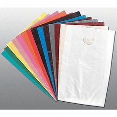 various colored paper bags are stacked on top of each other