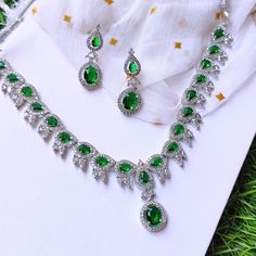 Discover the allure of artisan craftsmanship with this Handmade Emerald Green Crystal Necklace Set. Skillfully crafted with attention to every detail, this set features a stunning silver-plated necklace adorned with vibrant green crystals and matching earrings. Each piece is designed to add a touch of elegance and sophistication to your ensemble, making it perfect for weddings, parties, and special occasions. Materials: Silver-Plated Metal: Handcrafted with premium silver plating, offering both Necklace Set Diamond, Punjabi Necklace, Bollywood Necklace, Pakistani Necklace, Green Crystal Necklace, Necklace Set Silver, Ad Earrings, Diamond Necklace Indian, Rose Gold Diamond Necklace