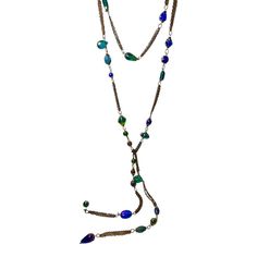 This is part of Chairish’s Costume Jewelry assortment.  Unique and rare vintage 57” lariat made of iridescent Murano glass interspersed with chain. This necklace is so versatile in that it can be wrapped up to 3x’s and of course tied lariat style. The glass is mainly in blues, greens, and purples of different shapes sizes and texture. A real stunner. Bohemian Lariat Chain Necklace For Party, Party Lariat Necklaces With Beaded Chain, Gold-tone Lariat Necklace For Layering, Adjustable Long Chain Necklace In Costume Jewelry Style, Adjustable Long Chain Necklace In Costume Style, Adjustable Long Costume Jewelry Chain Necklace, Adjustable Long Costume Jewelry Necklace, Adjustable Multi-strand Lariat Necklace For Party, Bohemian Lariat Jewelry For Party