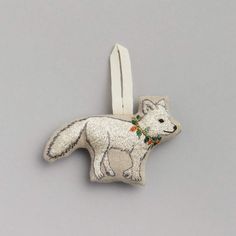 an ornament shaped like a fox with flowers on it