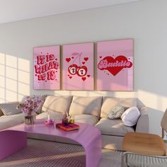 the living room is decorated in pink and white with two pictures on the wall above the couch