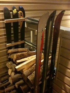 some skis and snowboards are stacked on top of each other in a room