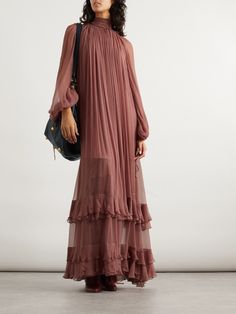 Chloé's Fall '24 collection has a care-free, bohemian feel. Featured in the ruffle-filled lineup, this gown is made from airy silk-crepon and has an elegant high neck with pleats that trace down through the breezy bodice to the tiered skirt. The attached slip provides just the right amount of coverage, while the adjustable ties on the cuffs allow you to cinch the sleeves. Pleated Gown, Designer Maxi Dress, Designer Mini Dresses, Edgy Chic, Exclusive Dress, Designer Gowns, Tiered Skirt, Clothes Collection, Beach Dresses