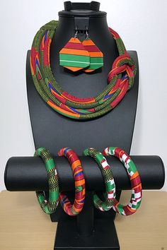 These are African print Ankara jewelry sets made with traditional Bamileke Neela print from the Bamileke tribe in Cameroon. This necklace doesn’t need much, put it over a simple slip dress and you are the talk of the whole party. This is a true conversation starter.Each set includes a 1 necklace, 1 pair of earrings and 4 small bangle bracelets- Necklace is tied behind the neck- Earrings have different shapes. You can receive one of the shape in the pictures or a different one: Heart, losange, Af Multicolor Traditional Pattern Necklace As Gift, Handmade Multicolor Jewelry For Traditional Ceremonies, Multicolor Round Beads Jewelry For Traditional Ceremonies, Bohemian Jewelry With Traditional Patterns As Gift, Multicolor Bohemian Jewelry For Traditional Ceremonies, Traditional Multicolor Jewelry For Traditional Ceremonies, Traditional Multicolor Jewelry For Ceremonies, Bohemian Jewelry For Traditional Ceremonies, Adjustable Multicolor Jewelry Sets For Festivals