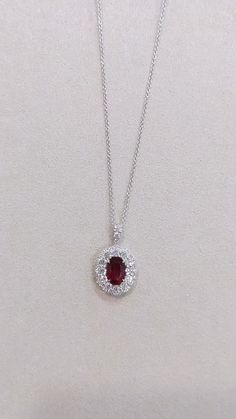 Discover the epitome of aesthetic splendor with our exquisite 2.16 Ct. Ruby and Diamond Pendant, meticulously crafted in luxurious 18K White Gold. This captivating piece features a radiant ruby gemstone complemented by dazzling diamonds, creating a harmonious masterpiece that exudes timeless elegance. Elevate your jewelry collection with this enchanting pendant that captures the essence of sophistication and beauty. 💎❤️✨ #RubyPendant #Diamonds #AestheticJewelry Oval Ruby Necklace With Brilliant Cut, Elegant Ruby Oval Pendant Necklace, White Gold Oval Ruby Necklaces, Elegant Ruby Necklace With Oval Pendant, Elegant Ruby Necklace With Halo Setting, Oval Ruby Necklaces In White Gold, Formal Ruby Necklace With Oval Pendant, Exquisite Red Oval Necklaces, Red Brilliant Cut Pendant Necklace