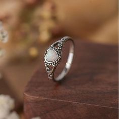 Materials: Sterling Silver Gemstone: Opal Gem color: White Band color: Silver/Rose gold Style: Minimalist Made to Order D E T A I L: Metal Type: sterling sliver (shown in the picture) ◆Size: US 6-10 ◆Center stone:  Opal ◆Gem color: White(shown in the picture) ◆Shape:3.3*3.3mm heart cut ◆Total weight:1.2g All of our jewelry are hypoallergenic and tarnish resistant. We wish to create lasting pieces that everyone can cherish, no matter the price point. O T H E R ∙ I N F O R M A T I O N * All items are nicely packaged ready to gift in elegant jewelry boxes. * If you can't find the information you need or need some advice for your design? Feel free to contact us. We are fast to reply :) T U R N ∙ A R O U N D ∙ T I M E * All items are custom made to order. Our turn around time is about 6 - 10 bu Wedding Engagement Gifts, Pattern Ring, Statement Ring Silver, Boho Ring, Antique Design, Unique Gemstones, Anniversary Wedding, White Opal, Precious Gemstones